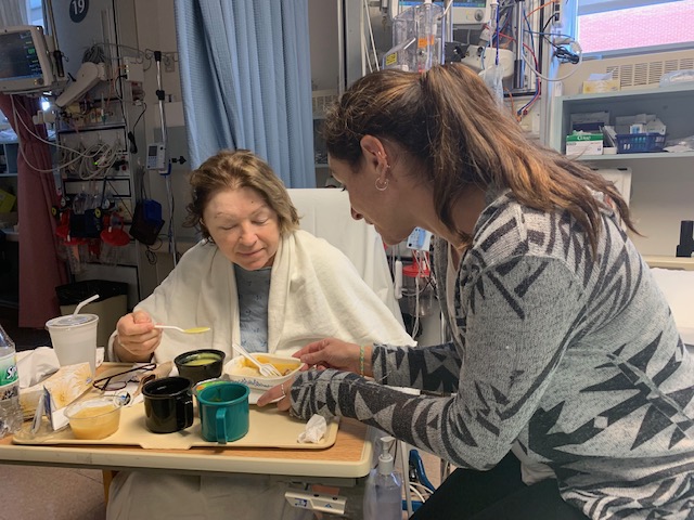 Laura bedside with her mother Christine.